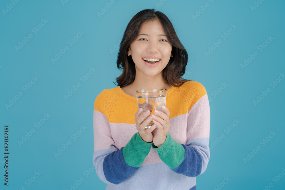 Cheerful woman holding a glass of water Cheerful woman holding a glass of water