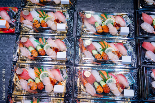 Various flesh sushi and sashimi ready to eat in plastic box package at Food shelves and freezers in seafood market