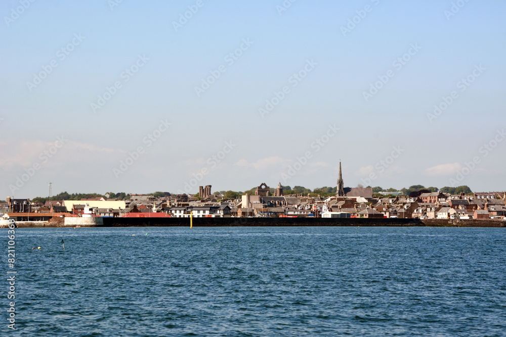 The distant coastline of the old town from afar from the sea side under a clear sky The distant coastline of the old town from afar from the sea side under a clear sky