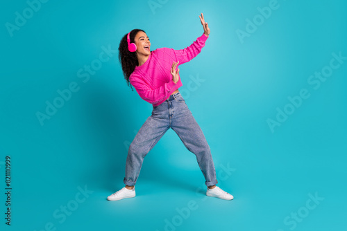 Full size photo of pretty teen girl dance enjoy music wear trendy pink outfit isolated on aquamarine color background