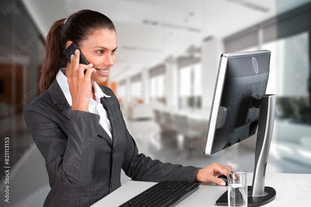 Young friendly female operator with headsets in a call centre. Young friendly female operator with headsets in a call centre.