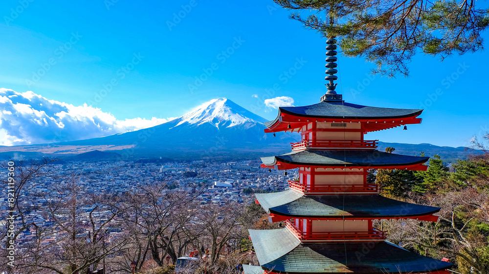 The iconic view of Mount Fuji with the red Chureito pagoda and Fujiyoshida city from Arakurayama sengen park in Yamanashi Prefecture, Japan.