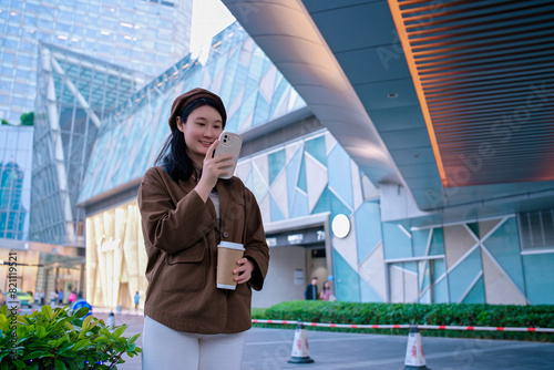 Modern Woman Using Smartphone in Urban Setting © 昊 周