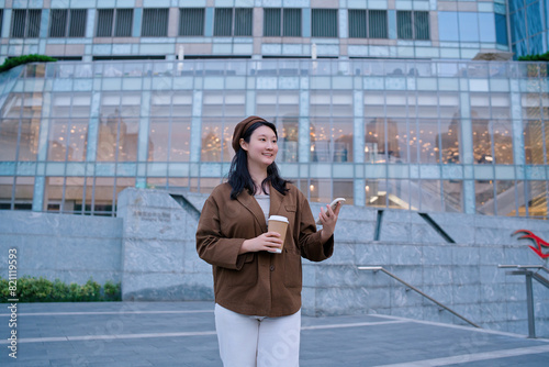 Confident Businesswoman with Coffee Outside Modern Building