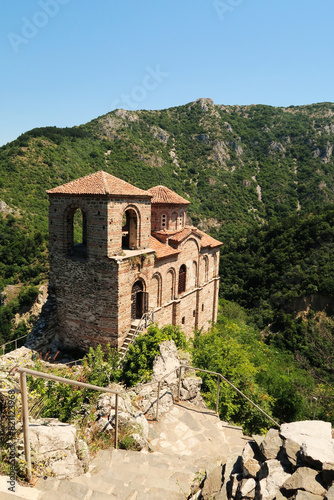 Stairs leading down to the Church of the Holy Mother, part of the medieval Asen's, Asens Fortress, surrounded by mountains and dense, lush vegetation, forest, near Plovdiv, Bulgaria photo