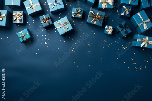 glamorous blue background with a small pile of wrapped gift boxes at one side seen from above for a birthday photo