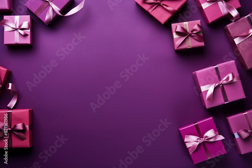 romantic purple or magenta background with a small pile of wrapped gift boxes at one side seen from above for a birthday