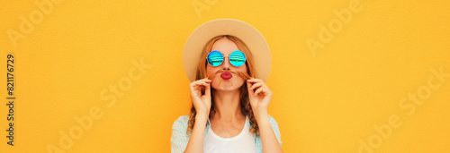 Portrait of funny young woman showing mustache her hair blowing lips wearing summer straw hat