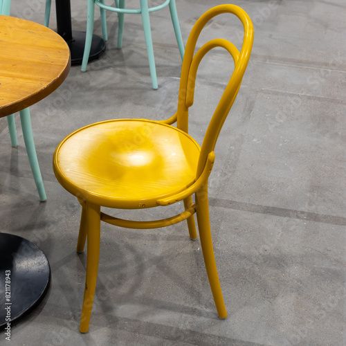 Colorful wooden chairs and tables in a public restaurant. Public places for eating quick meals.