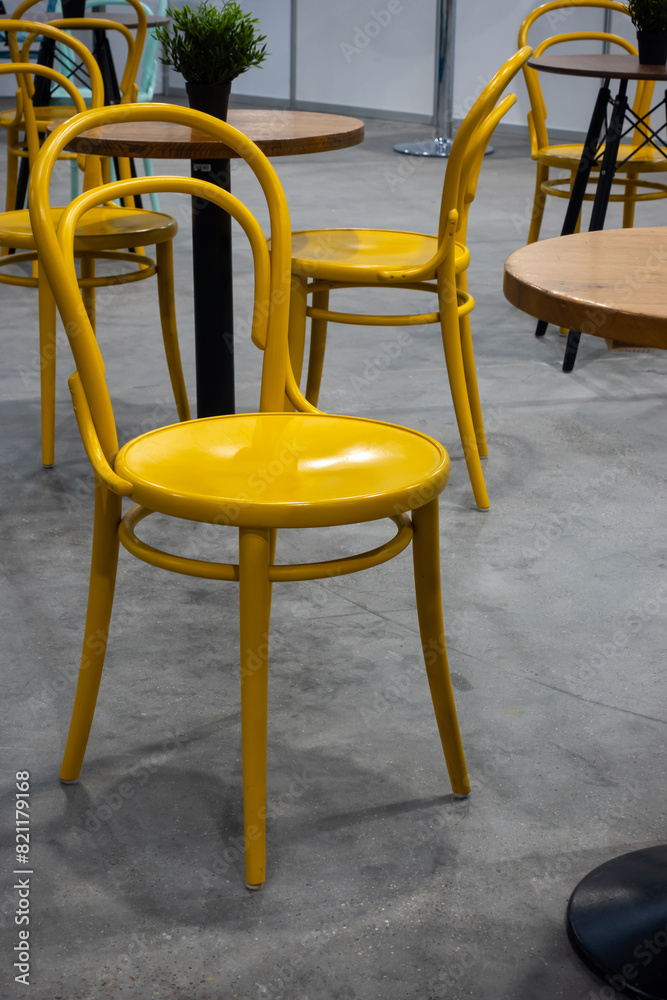 Colorful wooden chairs and tables in a public restaurant. Public places for eating quick meals.