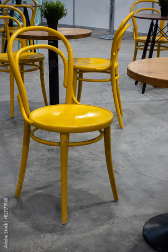 Colorful wooden chairs and tables in a public restaurant. Public places for eating quick meals.