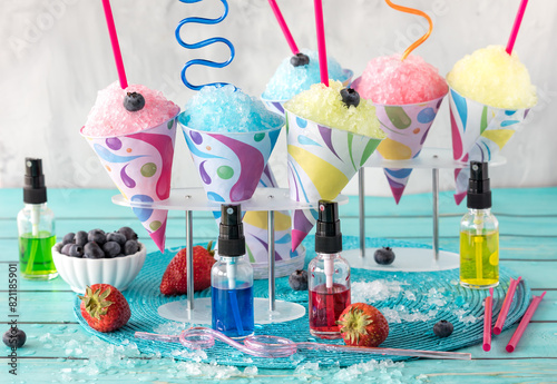 Various homemade snow cones with crazy straws, ready for sharing.
