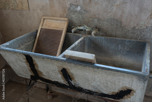 Washboards in a well worn laundry sink in an old building