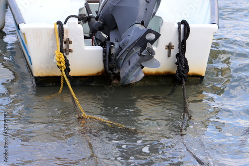 The propeller of a motor boat at the pier in the seaport.