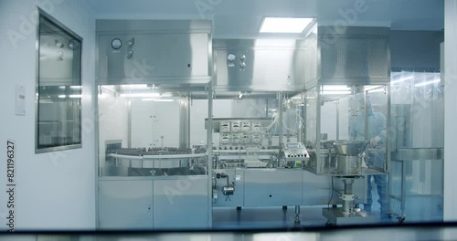 Factory Cleanroom. Pharmaceutical, Biotechnological and Semiconductor Creating Manufacturing Process. Scientists in Sterile Protective Clothing Work on a Modern Laboratory.