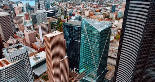 Drone descending along the high-rise buildings in the downtown of Seattle, Washington, US. View of the city at daytime. photo