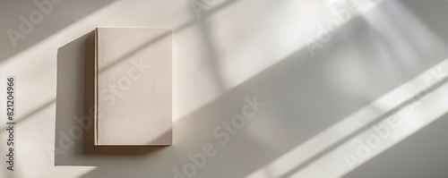 Simple notepad with white paper, placed on a white background, with natural shadows that accentuate its texture and thickness. Empty notebook ready to be filled. AI generated