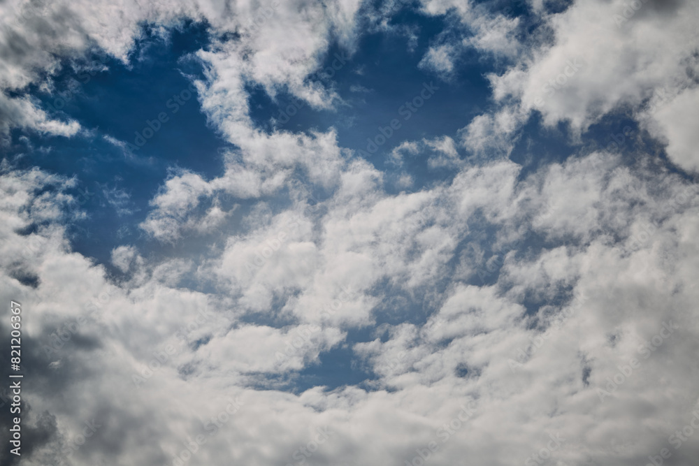 Swirling white clouds in the sky, large cloud formations Swirling white clouds in the sky, large cloud formations