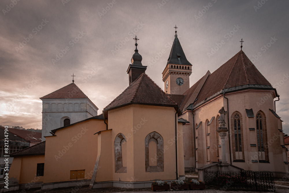 church on the side of a hill with a clock on its face church on the side of a hill with a clock on its face