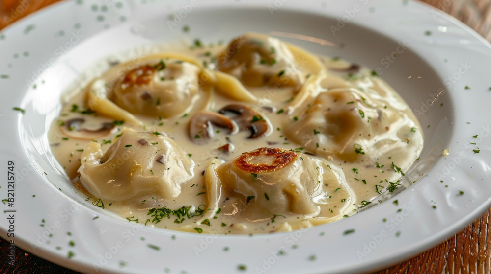 Close-up of traditional ukrainian varenyky dumplings in a creamy sauce, sprinkled with herbs on a white plate - authentic cuisine Close-up of traditional ukrainian varenyky dumplings in a creamy sauce, sprinkled with herbs on a white plate - authentic cuisine