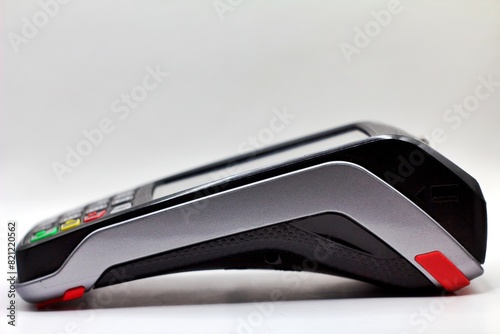 Shot of an empty card payment terminal in side view isolated on white background. Credit cards. Payments and transactions. Retail equipment.
