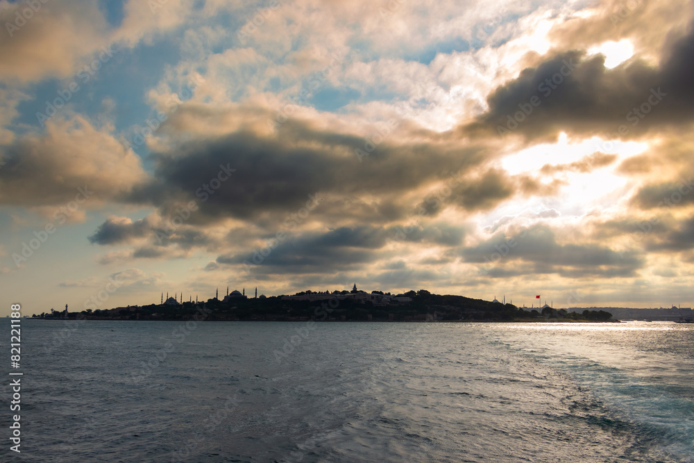 Silhouette of Istanbul at sunset with dramatic clouds view from a ferry Silhouette of Istanbul at sunset with dramatic clouds view from a ferry