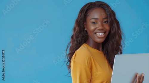 Smiling Woman Holding Laptop photo