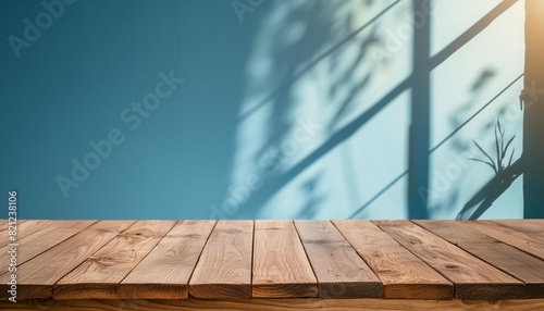 empty space wooden table top on blue wall background with window sunlight mockup scene display for products presentation