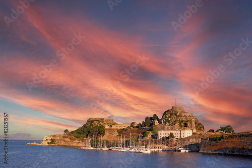 Port with yachts and sailboats Old fortress Corfu town Greece sunset photo