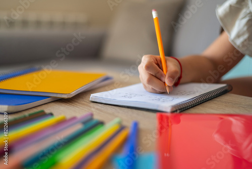 Close-Up Of A Primary School Girl Hand Doing Homework. Homeschooling. Summer School. Real Elementary Student. Back To School.