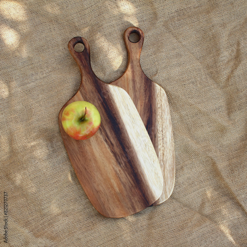 Two cutting boards with a yellow apple