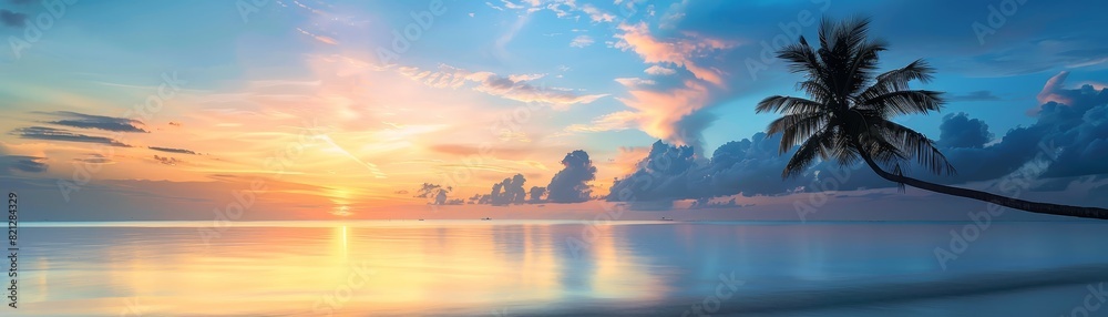 Naklejka premium Stunning tropical beach sunset with a silhouetted palm tree, calm ocean waters, and dramatic clouds glowing with vibrant colors.