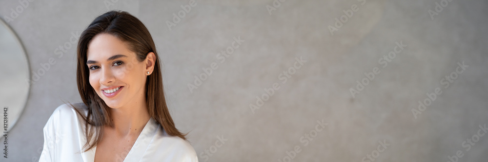 Closeup Portrait Of Beautiful Young Woman With Perfect Skin Looking At Camera, Attractive Millennial Lady With Natural Makeup Looking And Smiling At Camera While Posing In Bathroom At Home, Copy Space