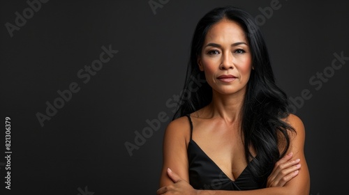 Stylish woman in black dress with arms crossed