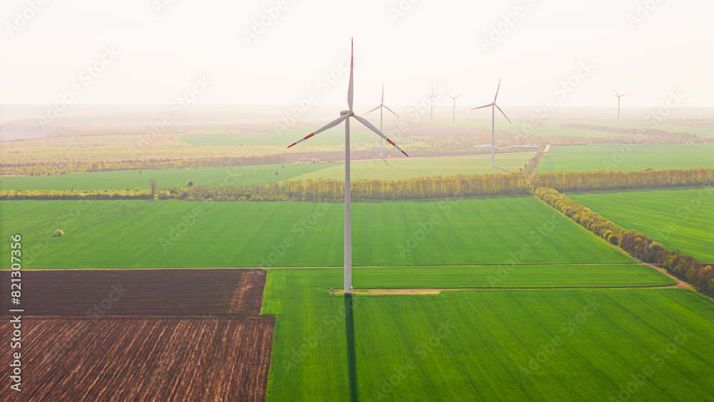 zero emission. Aerial view of green fields with wind turbines park ...