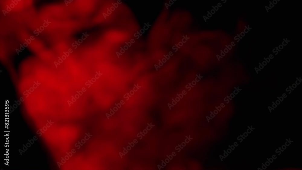 Explosion of Red Smoke or Powder on Black Blurred Background. Abstract, side view. Red soft puffs of smoke or steam mix chaotically on empty space. Particle explosion, bright light. Slow motion. Explosion of Red Smoke or Powder on Black Blurred Background. Abstract, side view. Red soft puffs of smoke or steam mix chaotically on empty space. Particle explosion, bright light. Slow motion.