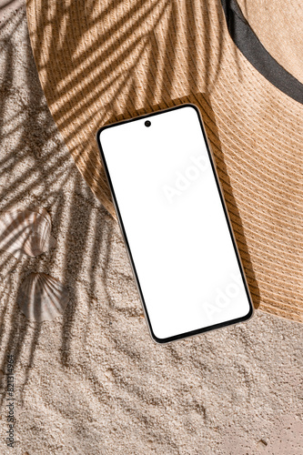 Fototapeta Naklejka Na Ścianę i Meble -  Aesthetic tropical summer business branding template, mobile phone empty screen mockup, straw hat on sand beach texture background with natural palm tree foliage sunlight shadow