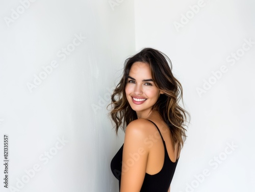 Stylish young brunette woman smiling on a white background. Beauty and fashion. Style.