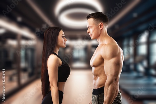 A fitness sporty young couple in a gym.