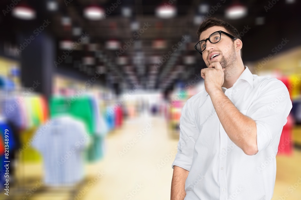 Happy man choosing in shopping center Happy man choosing in shopping center