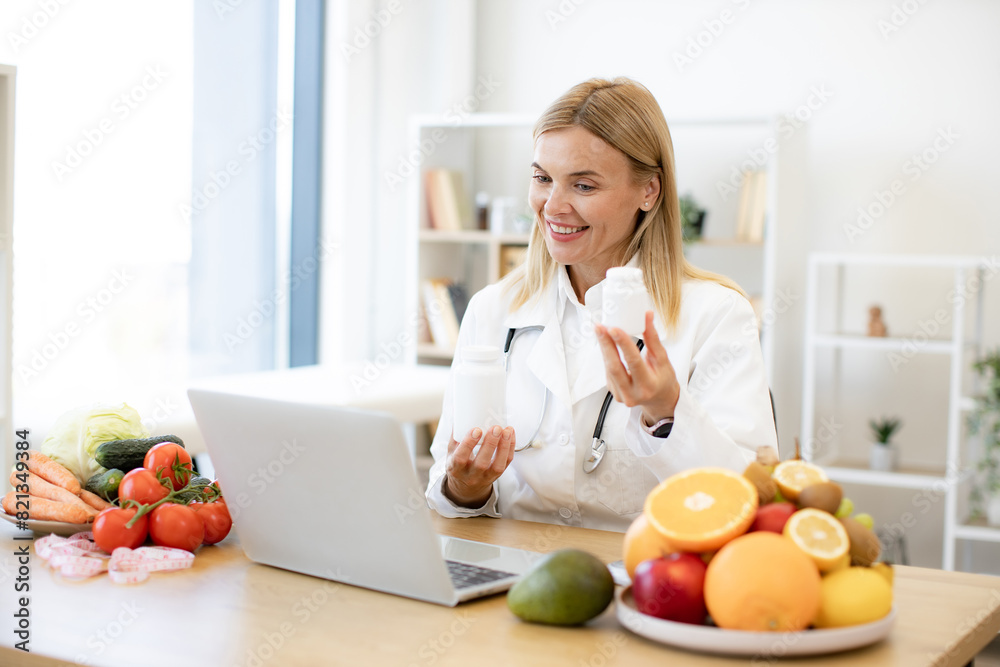 Mature nutritionist female doctor explaining medical treatment to the patient through a video conference using laptop. Telehealth and telemedicine concept. Mature nutritionist female doctor explaining medical treatment to the patient through a video conference using laptop. Telehealth and telemedicine concept.