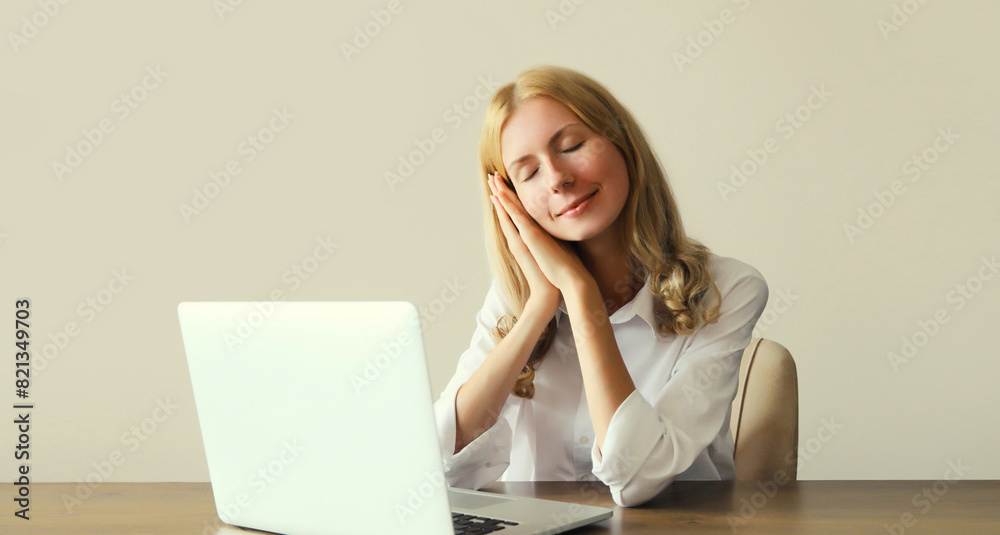 Tired overworked sleeping woman employee while working with laptop in office Tired overworked sleeping woman employee while working with laptop in office