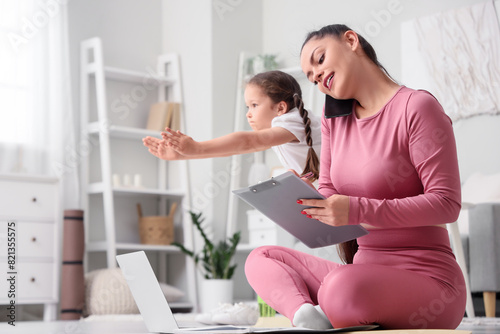 Working mother with her lit...