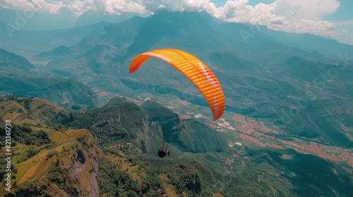 Paraglider Flying Over Mountain Range