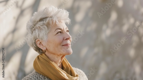 Portrait of a happy  70 years old woman, looking far away in the distance