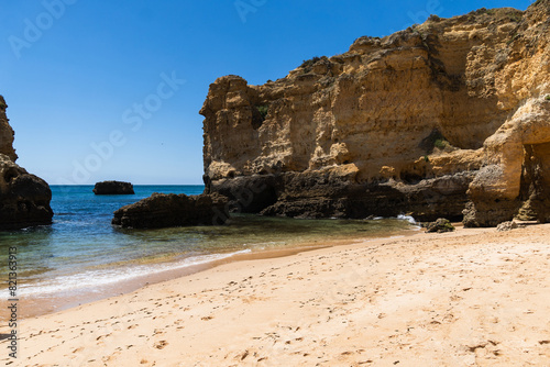 São Rafael beach, Albufeira, Algarve, Portugal. Sunny day. Rocks and cliffs on the beach. Crystal clear sea
