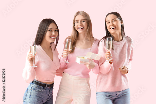 Three happy young women cel...