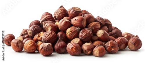 A collection of healthy hazel nuts stacked on a clean, white surface.