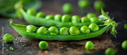 Fresh pea pod with scattered peas photo