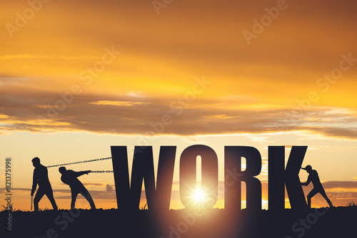 Silhouettes of people drawing the word WORK on a sunset background, business concept